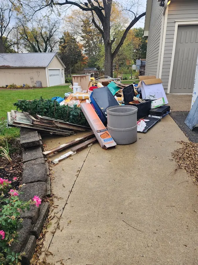 Dumpster being loaded with debris for Estate Cleanout Dumpster Rental in Garden Grove